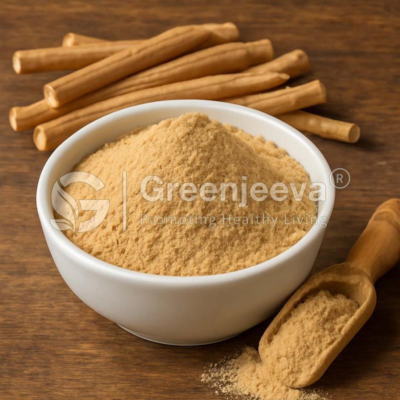 Bowl of fine brown Ashwagandha Extract Powder with a wooden scoop, alongside sticks of the herb, on a wooden surface.