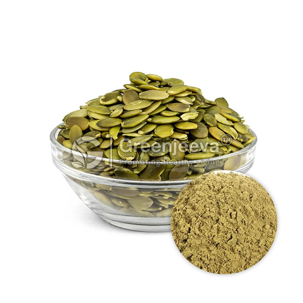 A glass bowl filled with green pumpkin seeds beside a small mound of pumpkin seed powder.