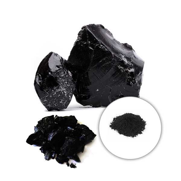 Two large chunks of Shilajit and a smaller pile of its powdered form.