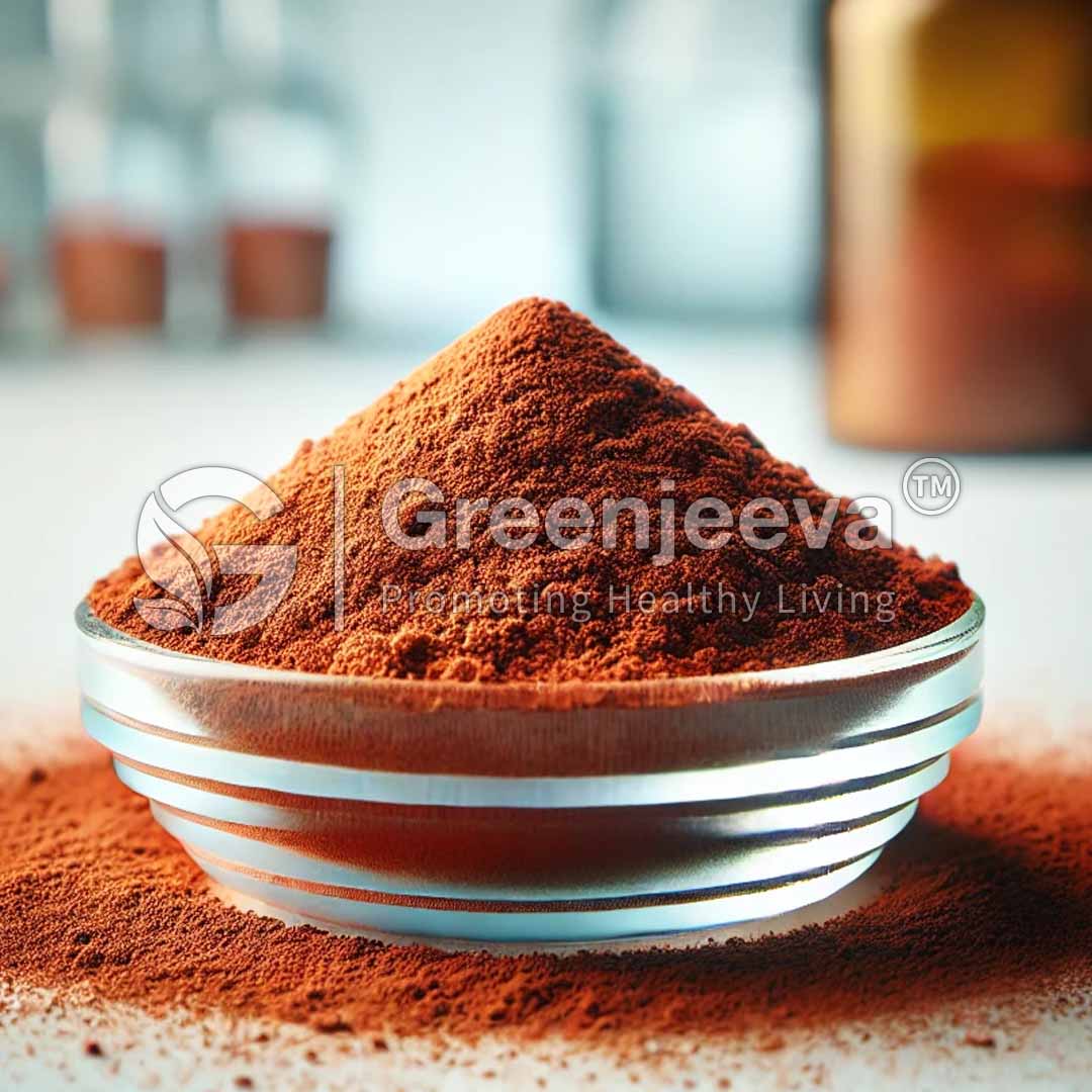 A close-up of a bowl filled with vibrant ferrous furmate powder on a light surface, with a blurred background and Greenjeeva logo.