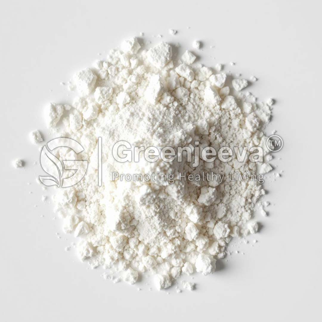 A mound of fine calcium carbonate granular Dc grade (oyster shell) powder on a light surface, showcasing its textured, granular appearance. Branding: "Greenjeeva - Promoting Healthy Living."